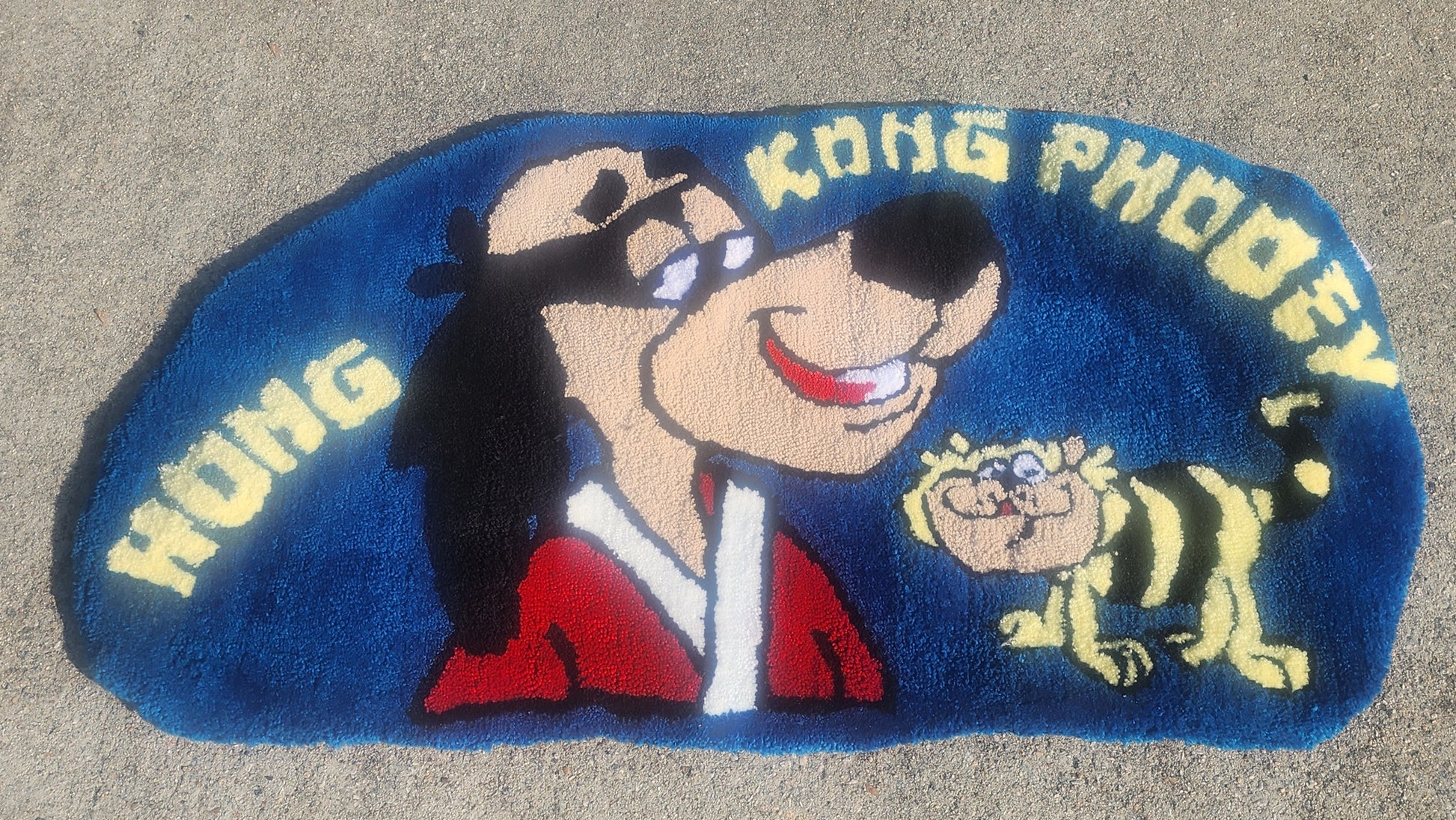 Cartoon character with a bee on a blue background with 'Kong Phooey' text.